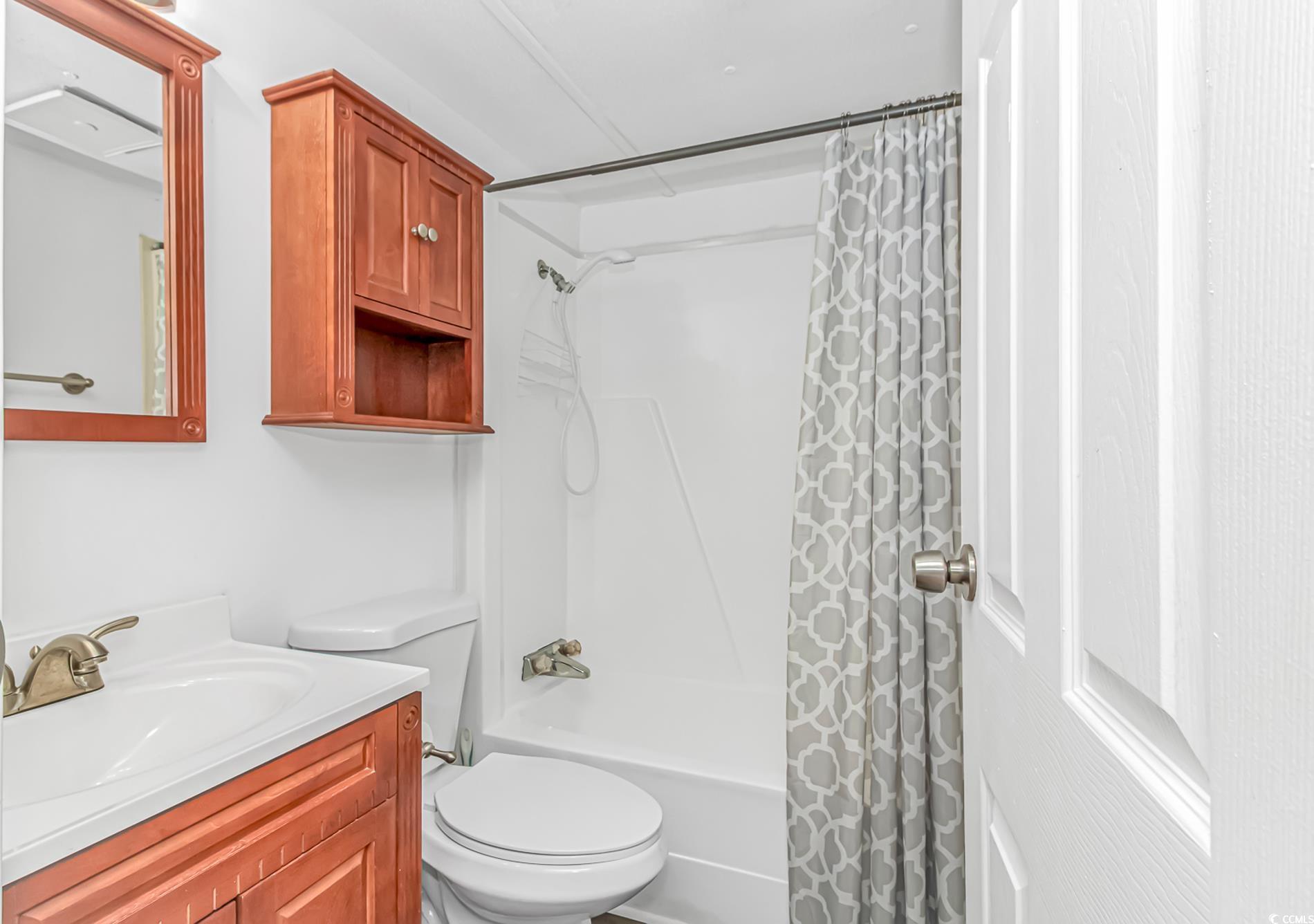 159 Offshore Drive Murrells Inlet, SC 29576 - Photo 23 of 35 Bathroom with vanity, toilet, and shower / tub combo with curtain
