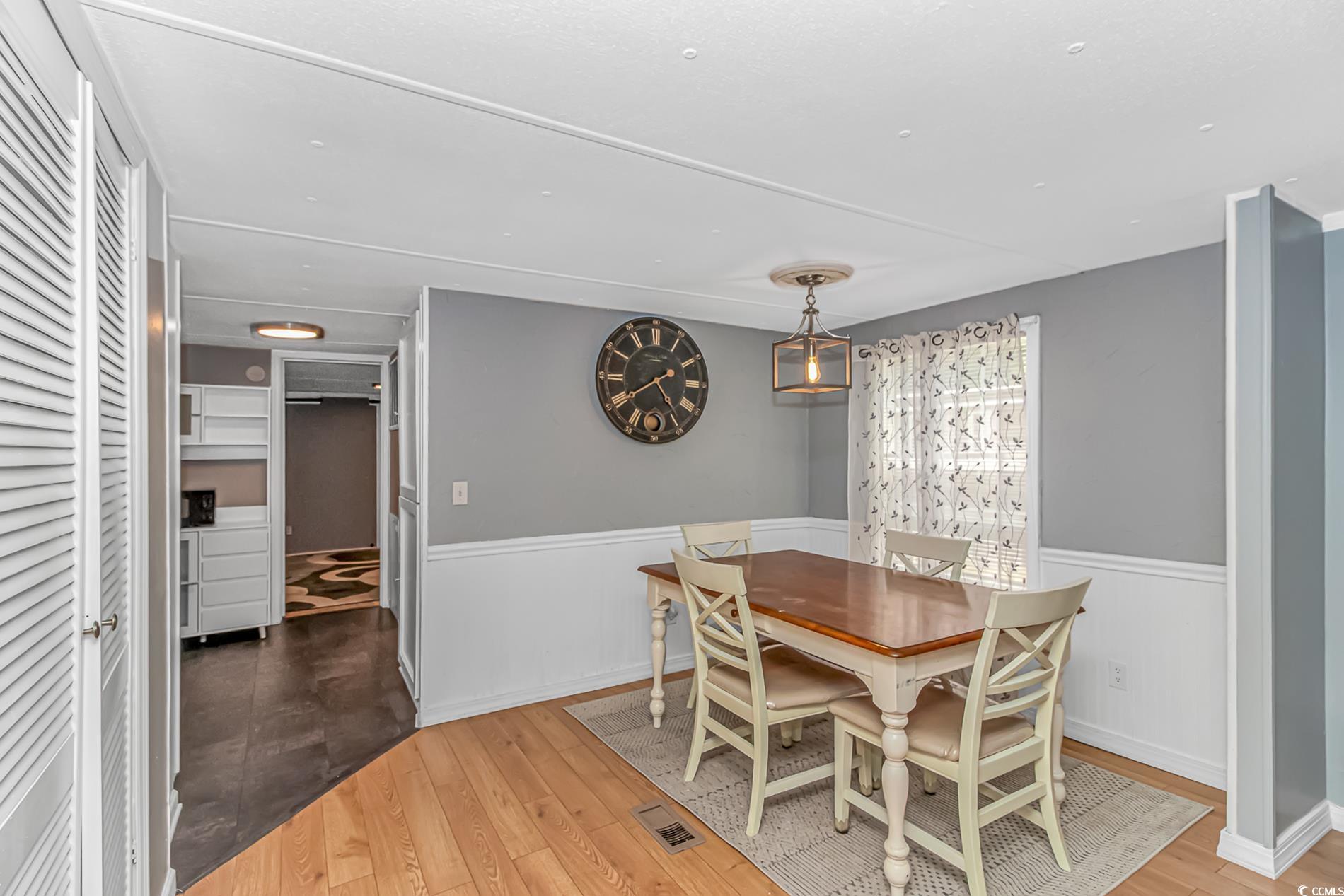 159 Offshore Drive Murrells Inlet, SC 29576 - Photo 7 of 35 Dining room with a wainscoted wall and wood finished floors