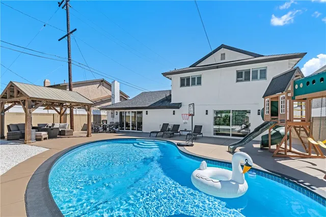 a swimming pool with outdoor seating