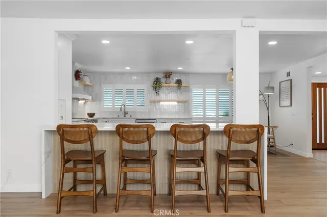 a dining area with furniture and wooden floor
