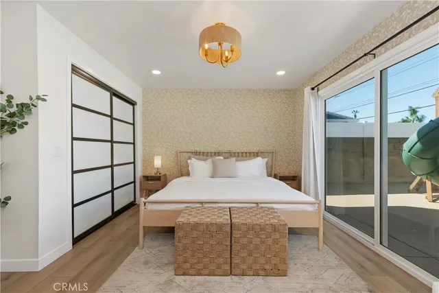 a bedroom with a bed and a lamp on dresser