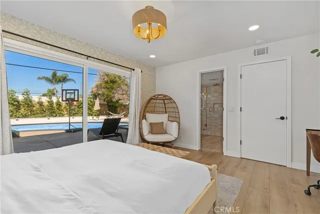 a bedroom with a bed and a large window