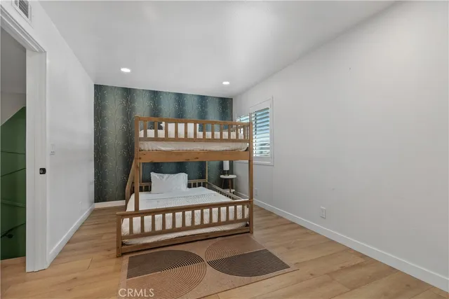 a bedroom with a bed and a night stand