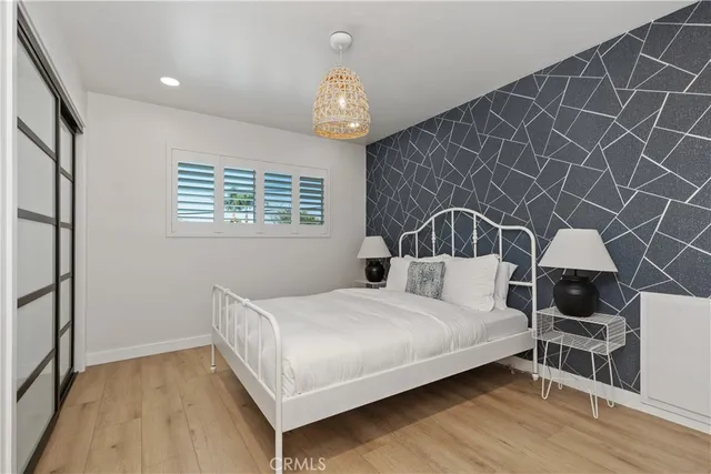 a bedroom with a bed next to a window with outer view