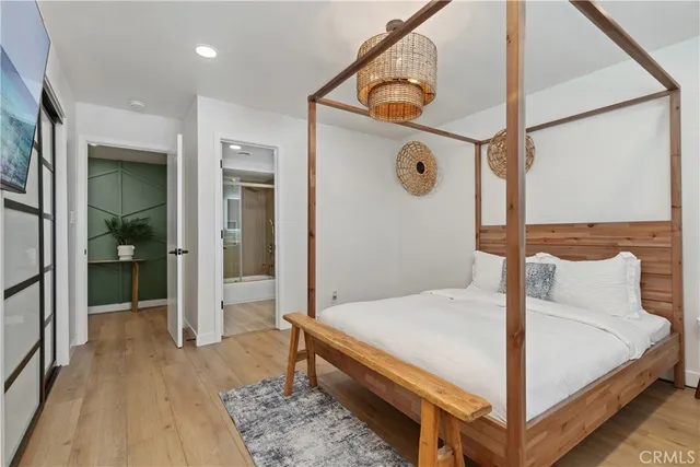 a bedroom with a bed and a mirror