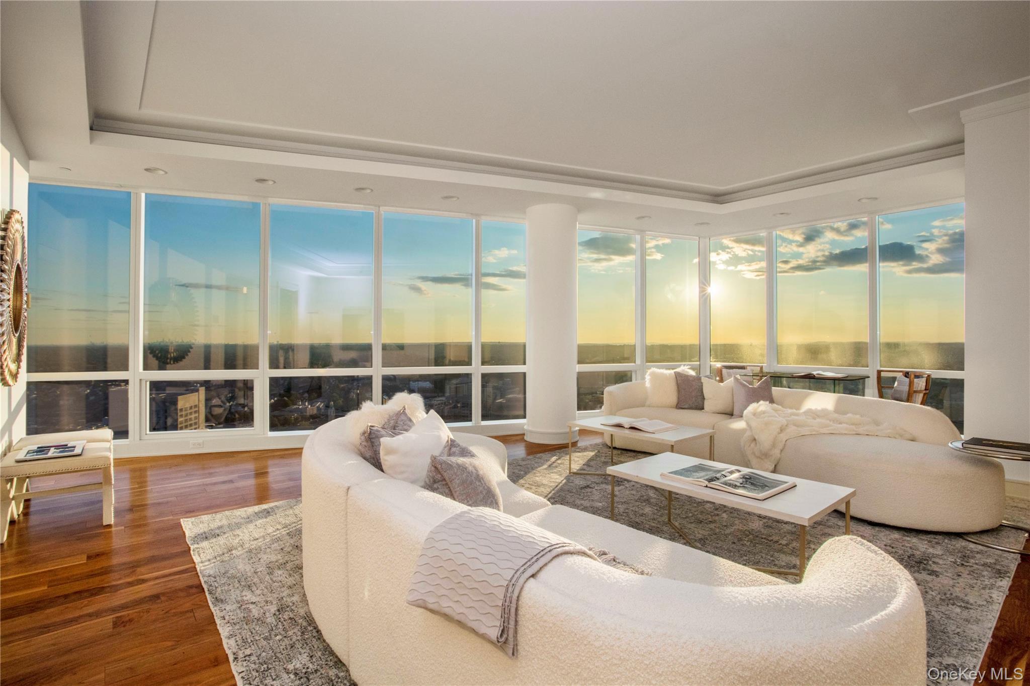 1 Renaissance Square, Unit PH4CD White Plains, NY 10601 - Photo 11 of 25 a living room with furniture large windows and wooden floor