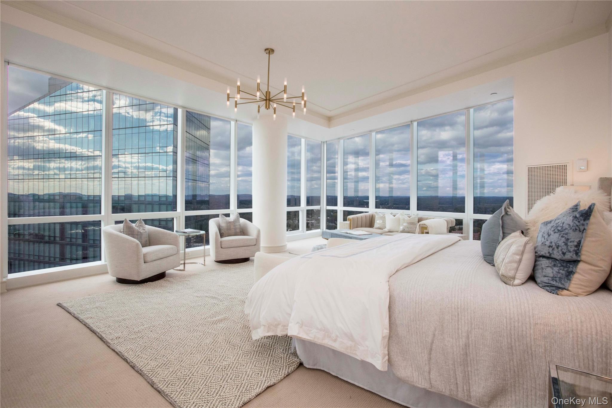 1 Renaissance Square, Unit PH4CD White Plains, NY 10601 - Photo 13 of 25 a bedroom with furniture and a large window