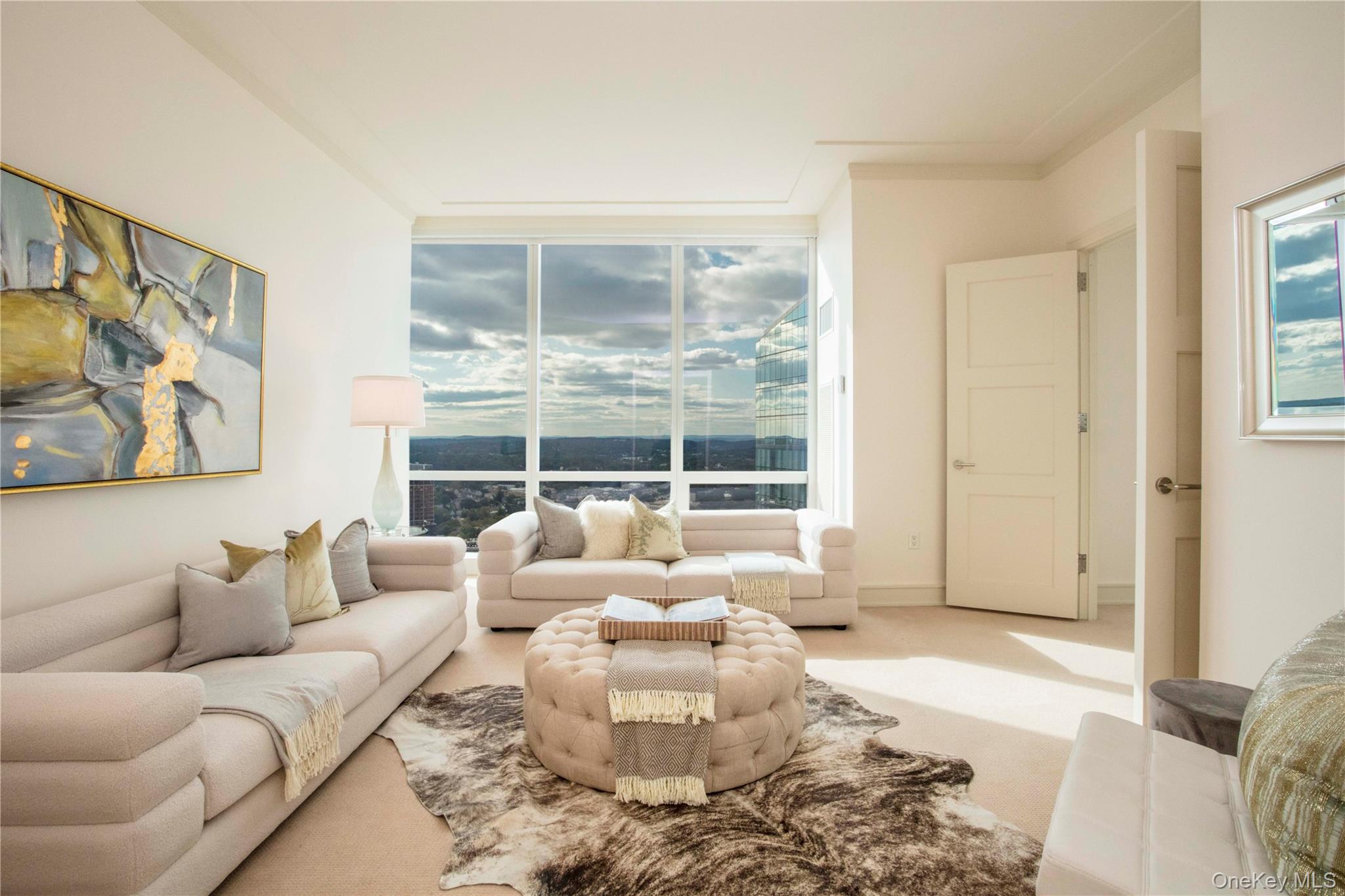 1 Renaissance Square, Unit PH4CD White Plains, NY 10601 - Photo 15 of 25 a living room with furniture and a large window