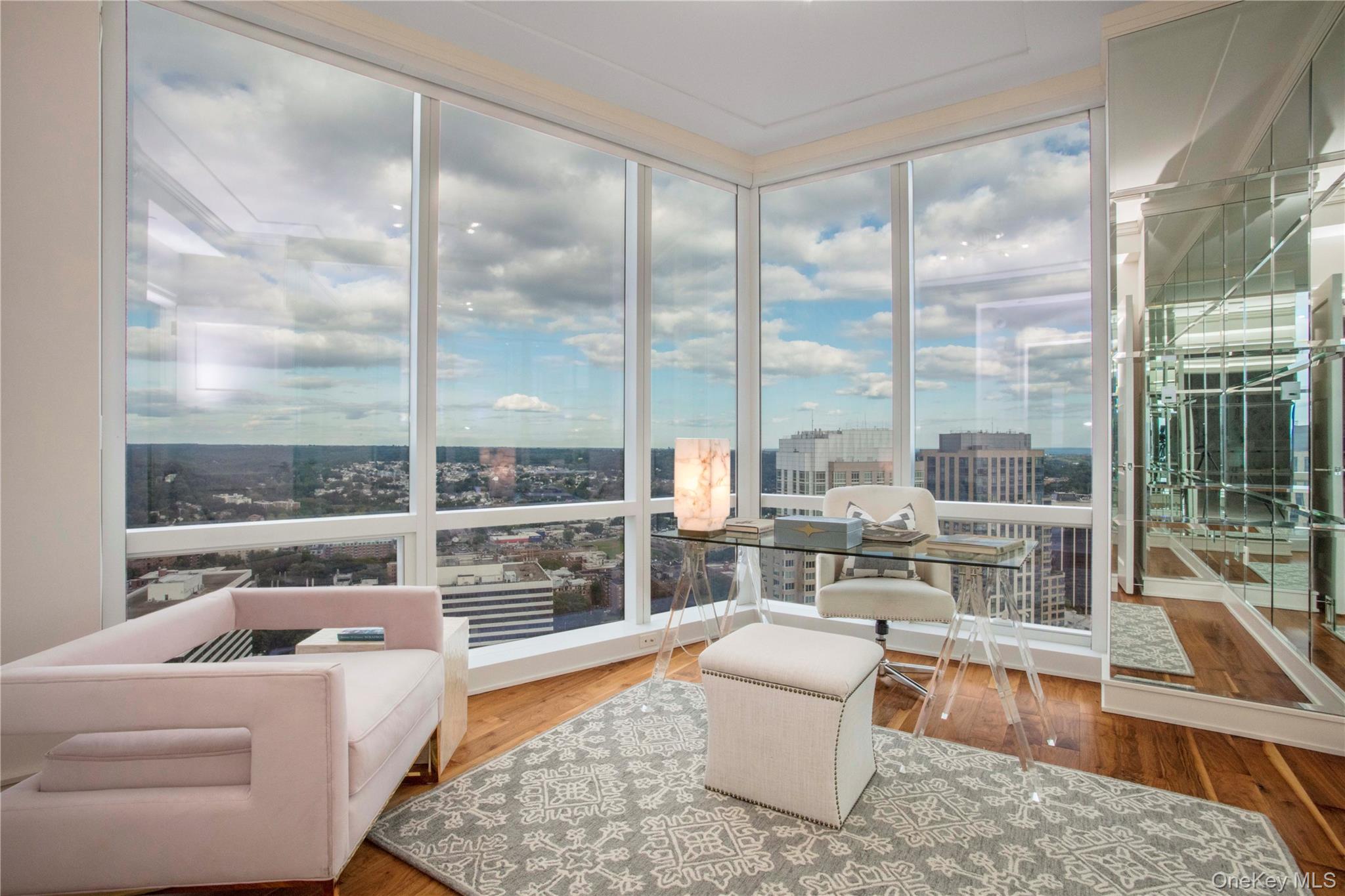 1 Renaissance Square, Unit PH4CD White Plains, NY 10601 - Photo 16 of 25 a living room with couch a table and a large window