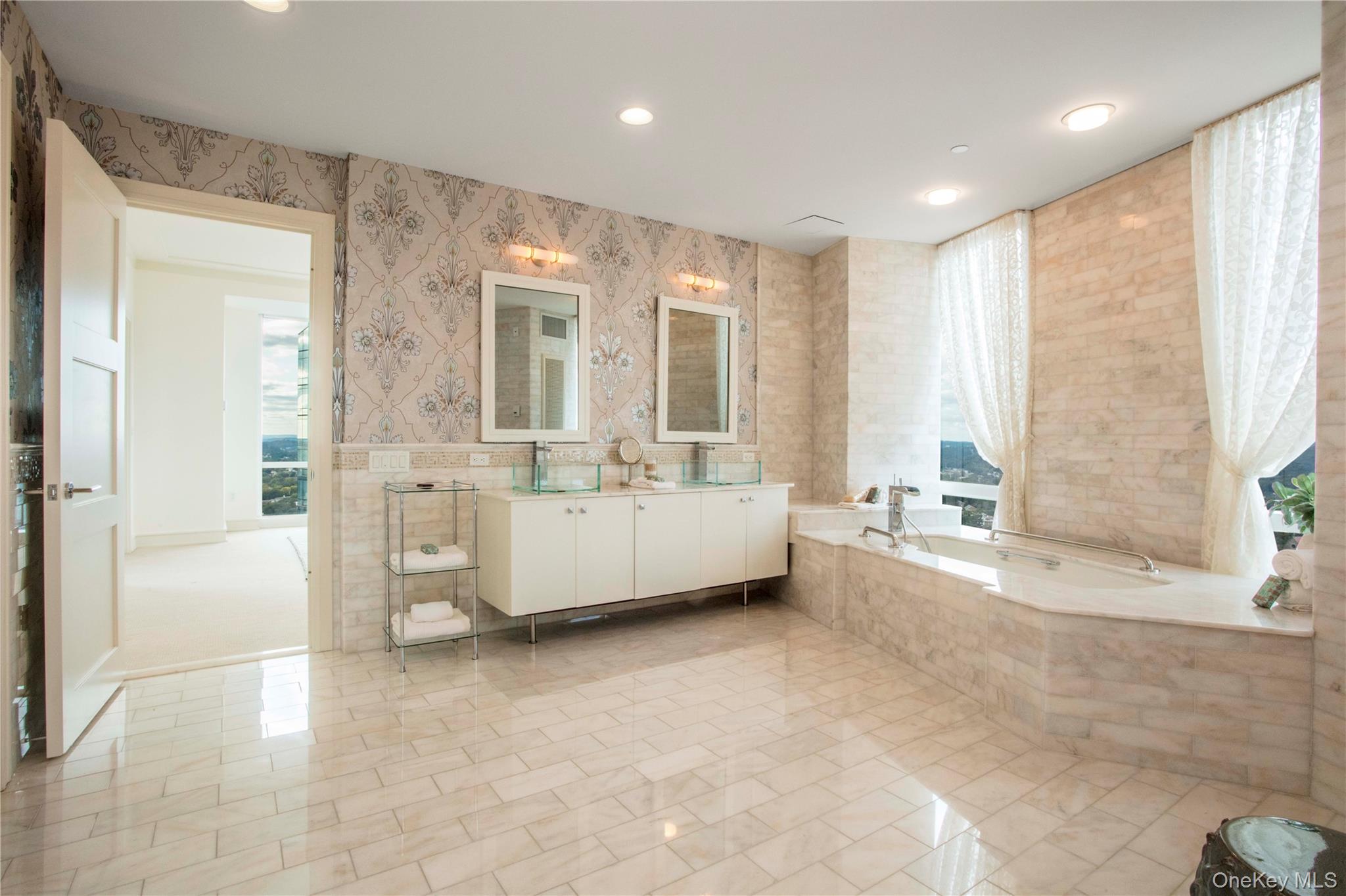 1 Renaissance Square, Unit PH4CD White Plains, NY 10601 - Photo 17 of 25 a bathroom with a tub mirror and window