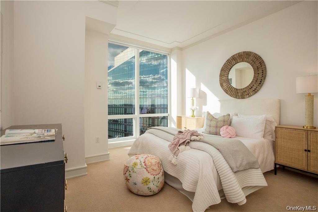 1 Renaissance Square, Unit PH4CD White Plains, NY 10601 - Photo 20 of 25 a bedroom with a bed and a window