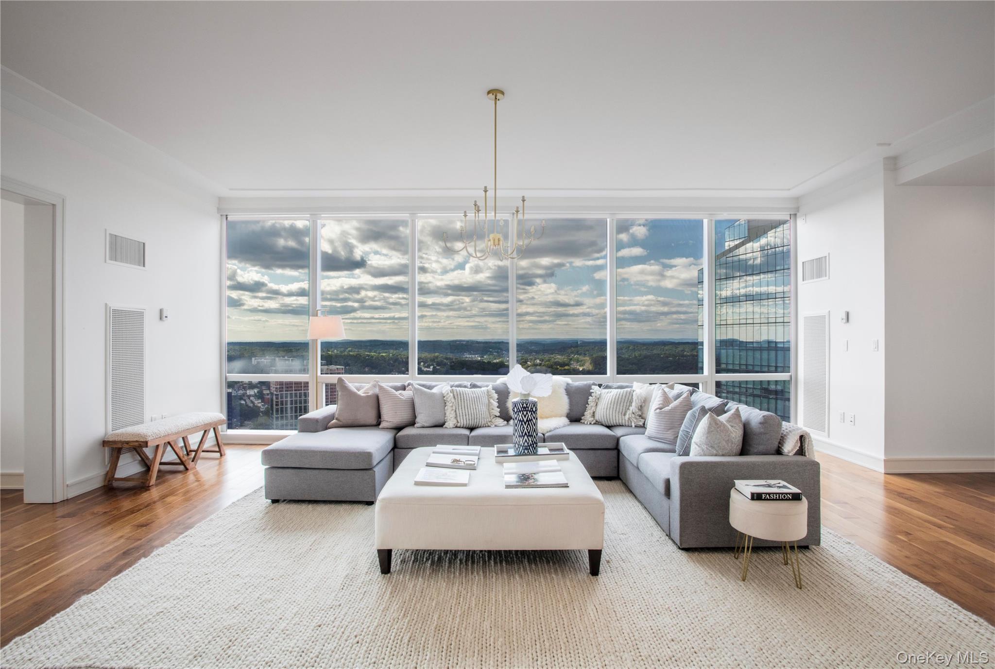 1 Renaissance Square, Unit PH4CD White Plains, NY 10601 - Photo 3 of 25 a living room with furniture and a large window