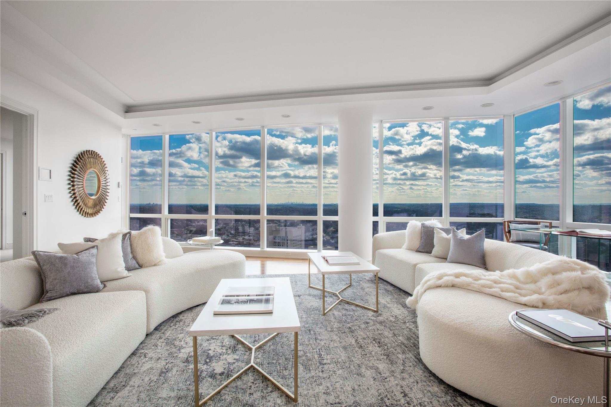 1 Renaissance Square, Unit PH4CD White Plains, NY 10601 - Photo 4 of 25 a living room with furniture and a large window