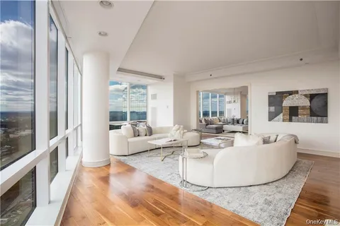 a living room with fireplace furniture and a large window