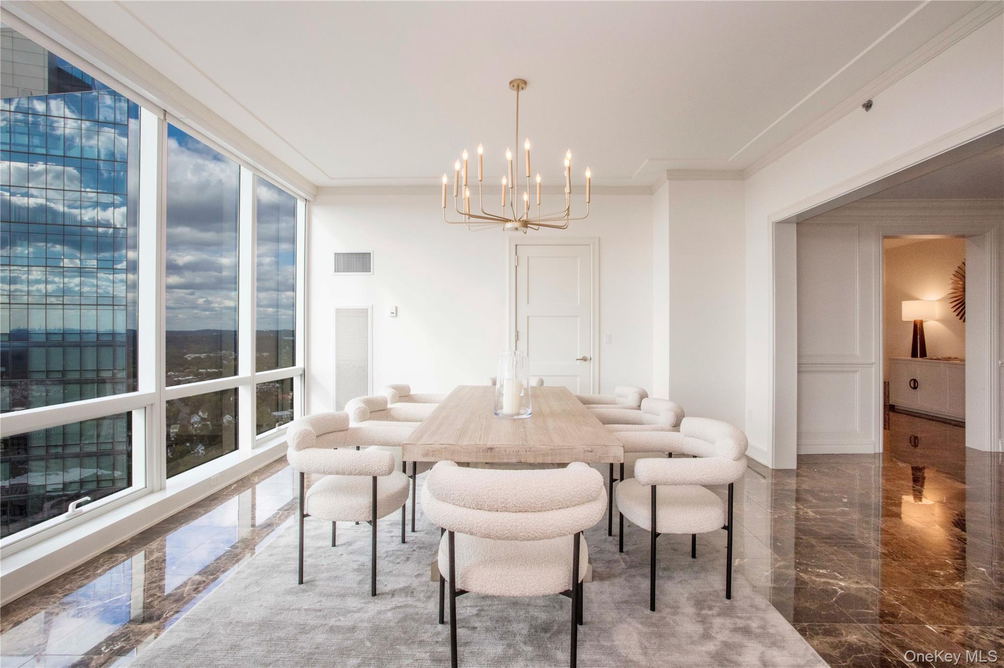 1 Renaissance Square, Unit PH4CD White Plains, NY 10601 - Photo 8 of 25 a view of a dining room with furniture window and wooden floor