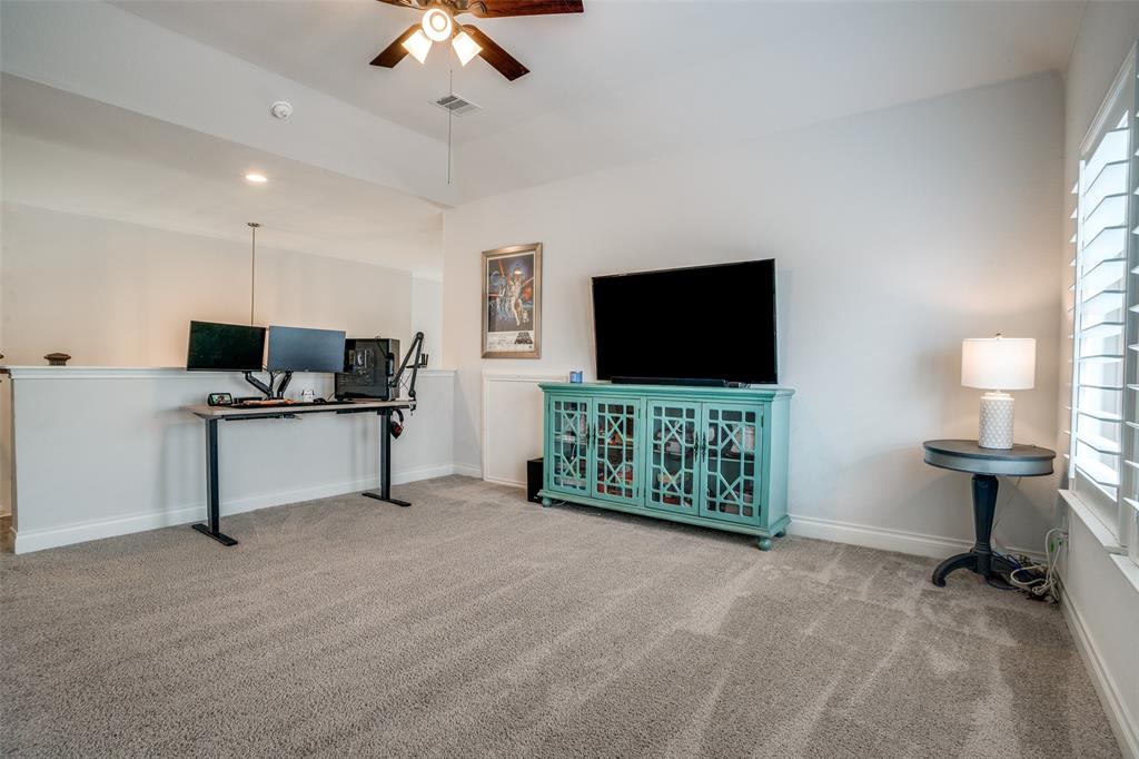 880 Manchester Avenue Prosper, TX 75078 - Photo 12 of 26 a living room with furniture and a flat screen tv