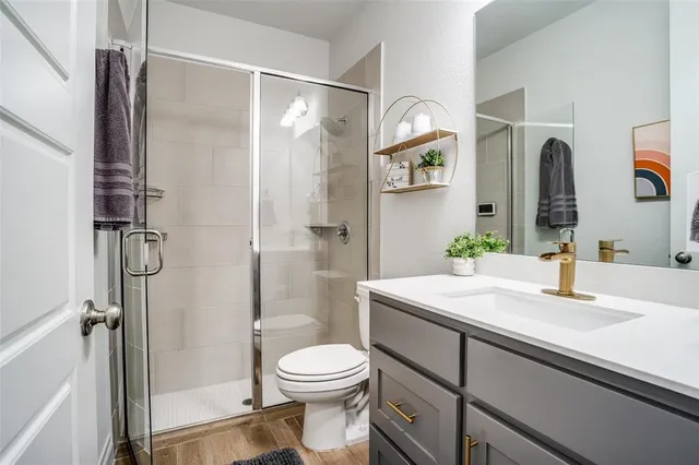 a bathroom with a sink toilet and shower