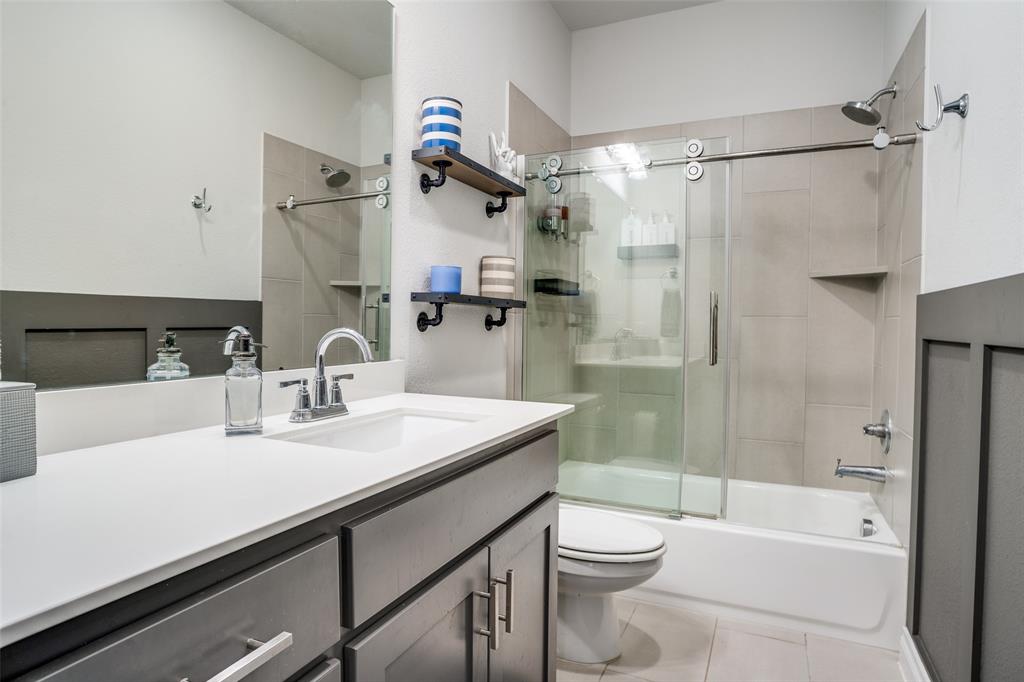 880 Manchester Avenue Prosper, TX 75078 - Photo 20 of 26 a bathroom with a sink a toilet and shower