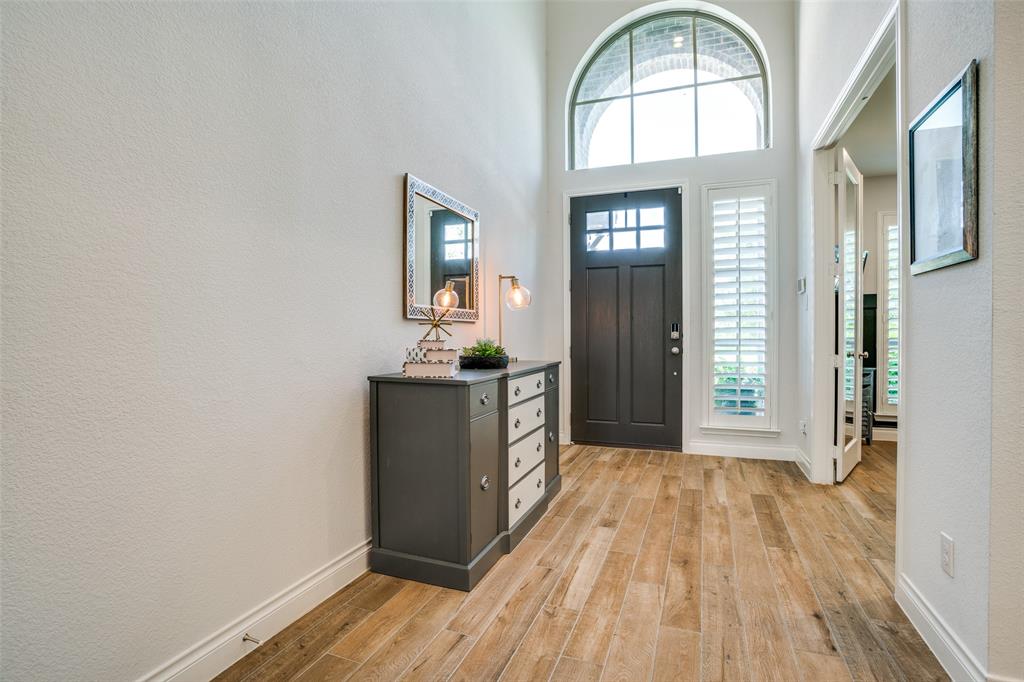 880 Manchester Avenue Prosper, TX 75078 - Photo 2 of 26 a view of a room with wooden floor and entryway
