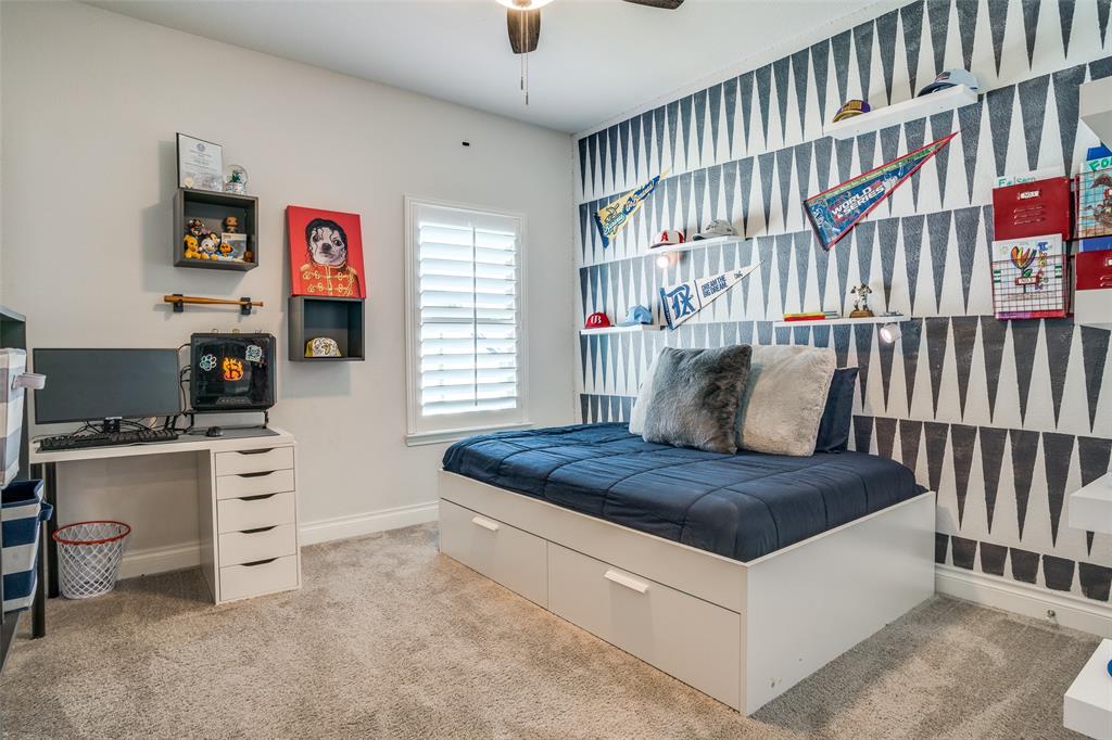880 Manchester Avenue Prosper, TX 75078 - Photo 21 of 26 a bedroom with a bed and a book shelf