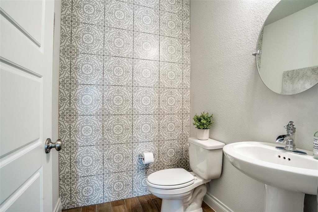880 Manchester Avenue Prosper, TX 75078 - Photo 22 of 26 a bathroom with a sink a toilet and a mirror