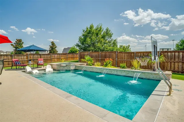 a view of a house with swimming pool and a yard