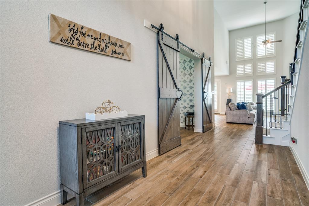 880 Manchester Avenue Prosper, TX 75078 - Photo 4 of 26 a view of a hallway with wooden floor and staircase
