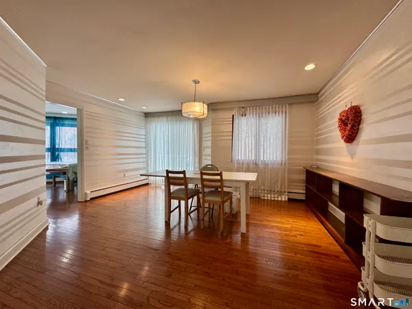 a view of a a dining room with furniture and wooden floor