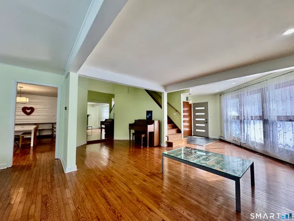 a living room with furniture and a wooden floor