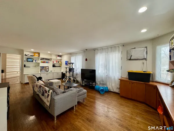 a living room with furniture and a flat screen tv