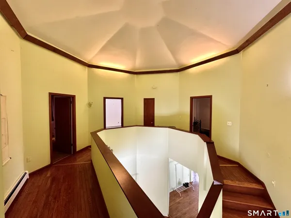 a bed sitting in a kitchen next to a window