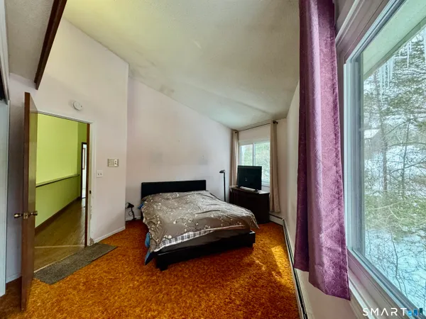 a bedroom with a bed and a window