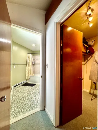 a bathroom with a glass door shower and a sink