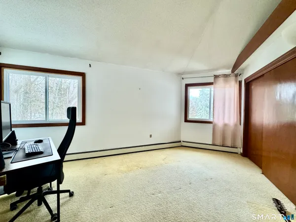 a view of a room with gym equipment and windows
