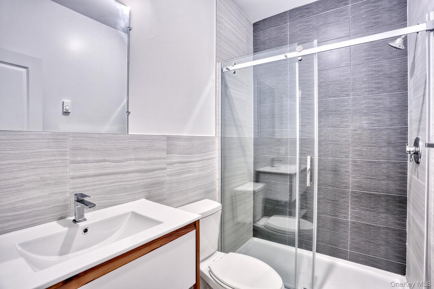 962 Rte 9W, Unit 305 Congers, NY 10920 - Photo 13 of 24 Lovely Primary Bath with vanity, a walk-in shower and tiled walls.