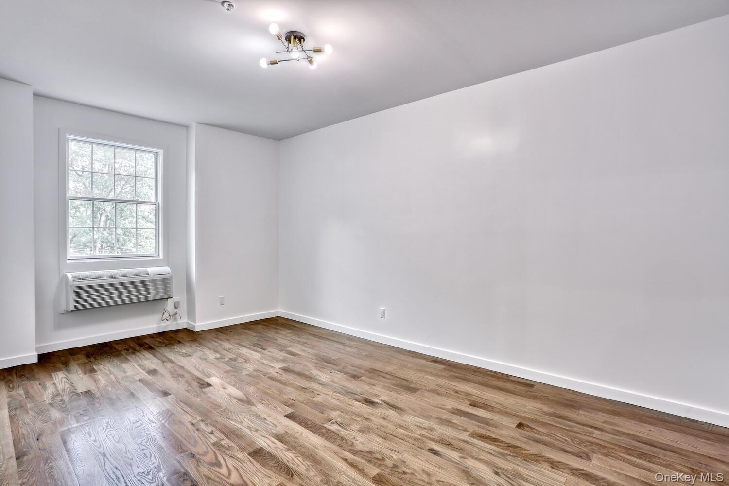 962 Rte 9W, Unit 305 Congers, NY 10920 - Photo 10 of 24 Nicely sized Primary Bedroom with wood flooring. Each room is equipped with it's own heating and cooling unit.
