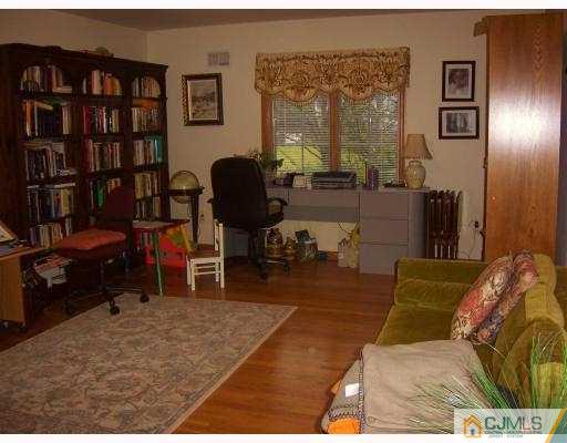 3 Maher Road Somerset, NJ 08873 - Photo 6 of 8 a living room with furniture and a book shelf