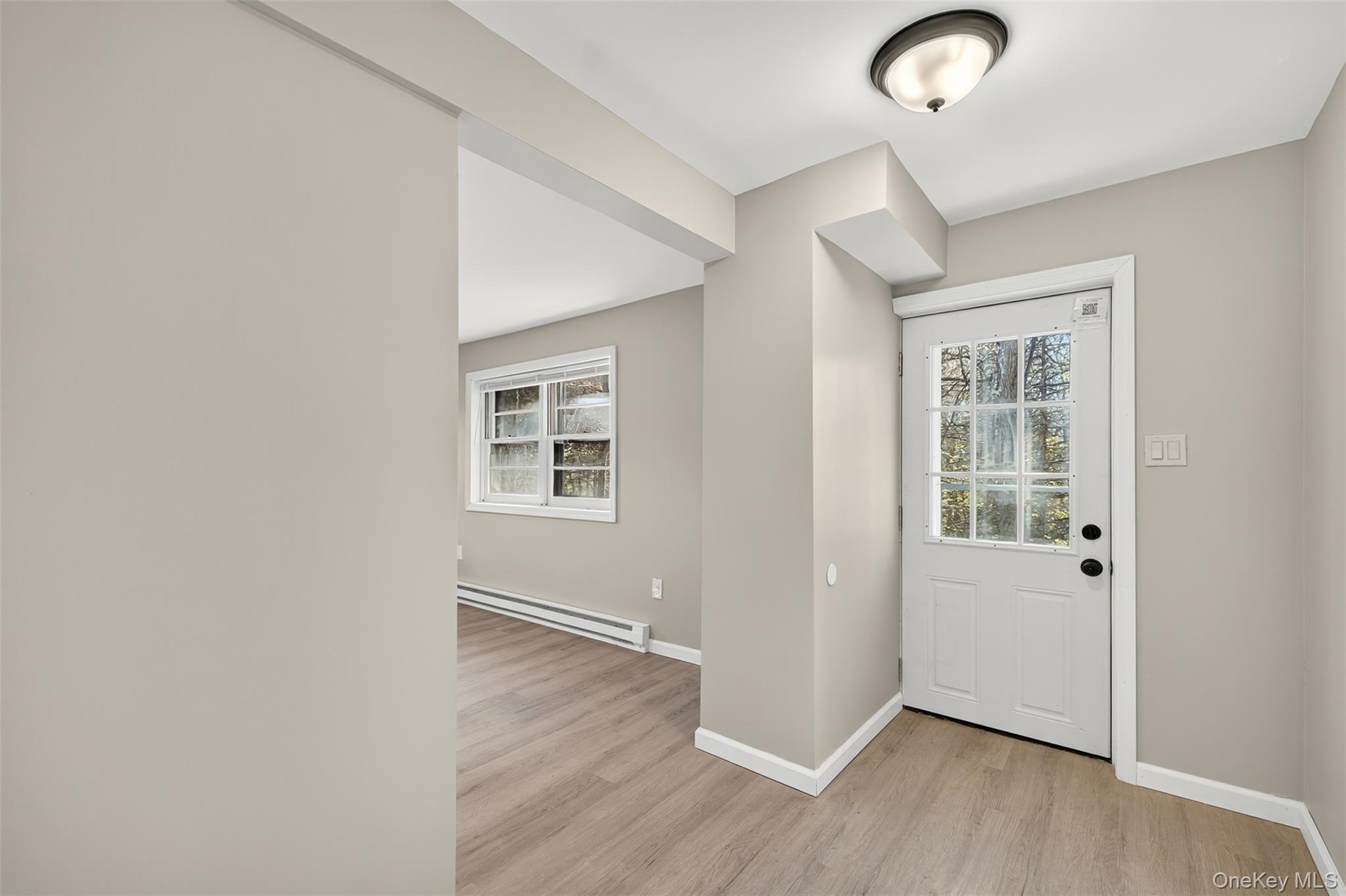 34 Round Hill Road Walden, NY 12586 - Photo 17 of 18 an empty room with wooden floor and windows