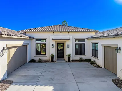 a living room with furniture a flat screen tv and a table