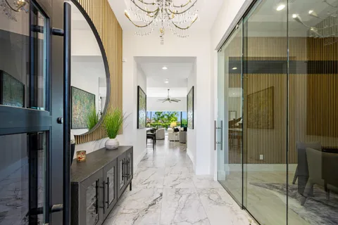 a living room filled with furniture and a potted plant