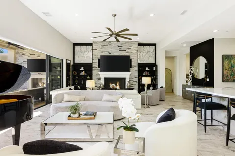 a living room with furniture fireplace and flat screen tv
