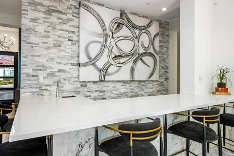 a view of a patio with dining table and chairs potted plants