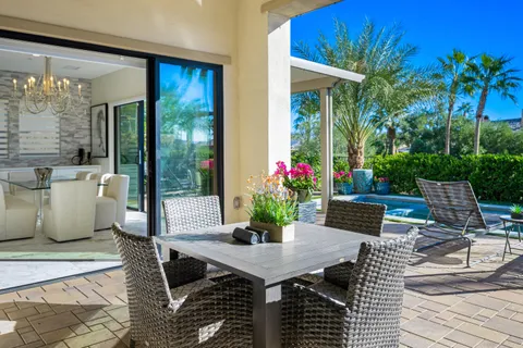 a view of a house with swimming pool patio and glass windows