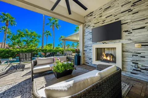 a view of a house with swimming pool and sitting area
