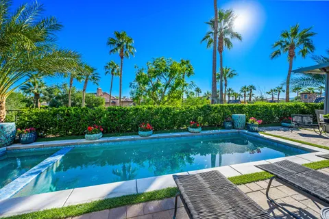 a view of a house with swimming pool and a porch