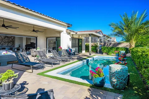 a kitchen with stainless steel appliances granite countertop sink stove and white cabinets with wooden floor