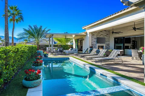 a kitchen that has a lot of white cabinets and a stove