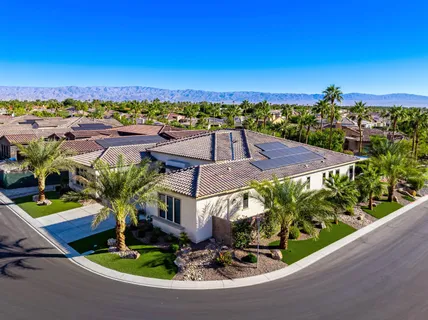 a view of a patio with table and chairs potted plants and floor to ceiling window and potted plants