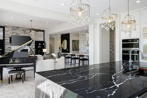 a bedroom with a large bed and a painting on the wall