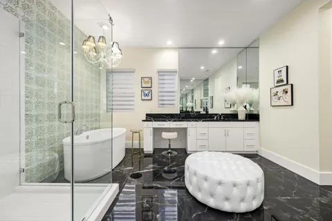a bathroom with a sink toilet vanity and shower